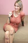 Charming blonde Tina Ray shows her sexy inked body and toys herself