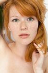 Redheaded teen with nice boobs Mia Sollis poses naked in a solo